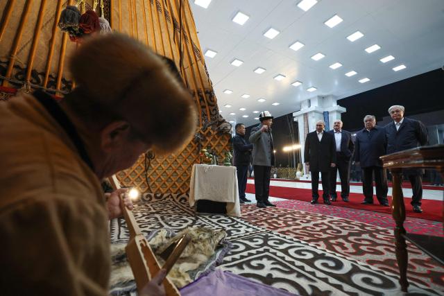 In this pool photograph distributed by the Russian state agency Sputnik, the Collective Security Treaty Organisation (CSTO) heads of state, including Russia's President Vladimir Putin, tour a national culture exhibiton on the eve of their meeting, in Bishkek on November 26, 2025. (Photo by Alexander KAZAKOV / POOL / AFP)