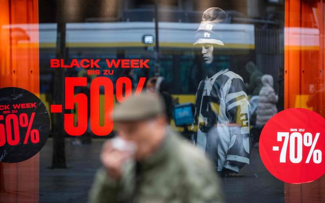 A clothing retailer advertises "Black Week" discounts at the Alexanderplatz shopping district in Berlin on November 26, 2025, ahead of the holidays season. (Photo by John MACDOUGALL / AFP)