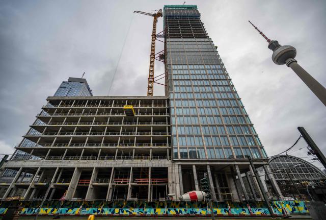 Work continues on the 134-metre-high "MYND" tower, now called "The Berlinian", at Berlin's Alexanderplatz, next to the landmark TV Tower (R), and the Park Inn hotel (L) on November 26, 2025. The tower, adjoining the Galeria department store, is expected to be completed in 2025. (Photo by John MACDOUGALL / AFP)