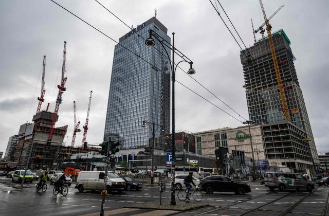 Work continues on the 134-metre-high "MYND" tower, now called "The Berlinian", (R) and the Covivio tower (L) at Berlin's Alexanderplatz, with the landmark Park Inn hotel, which also belongs to Covivio, in the centre, on November 26, 2025. The two high rises are expected to alter the capital's skyline when completed. (Photo by John MACDOUGALL / AFP)