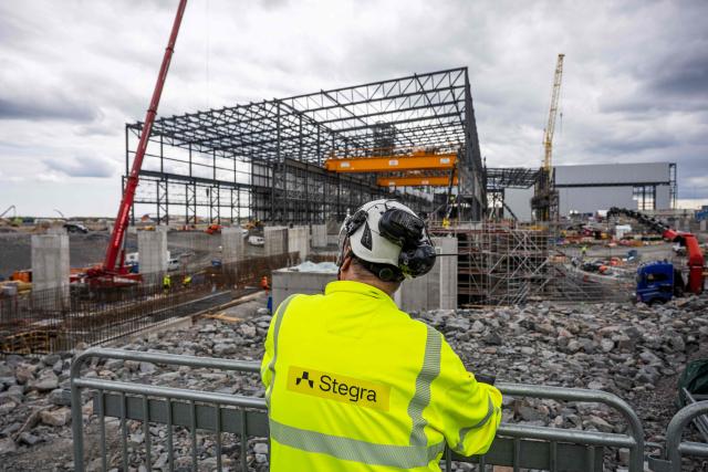 (FILES) The construction site of Stegras green-steel plant is pictured on June 10, 2025, in Boden, Northern Sweden. The Swedish Energy Agency said on November 26, 2025 it was giving some USD 40 million in support to low-carbon steelmaker Stegra, amid fears surrounding the ambitious startup's finances. Stegra is building a new steel mill it says will produce steel using technology that gives off 95 percent less CO2 emissions than traditional methods. Approximately 60 percent of the work has been completed. In October, Stegra announced another round of financing to bring in an additional 10 billion kronor (USD 1 billion) to cover higher project costs. (Photo by Jonathan NACKSTRAND / AFP)