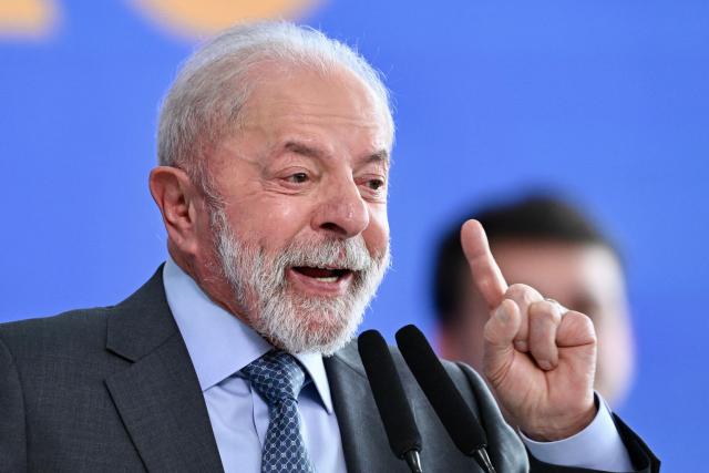 Brazil's President Luiz Inacio Lula da Silva gestures as he speaks during the signing ceremony of the new Income Tax Law at the Planalto Palace in Brasilia. on November 26, 2025. (Photo by Evaristo Sa / AFP)