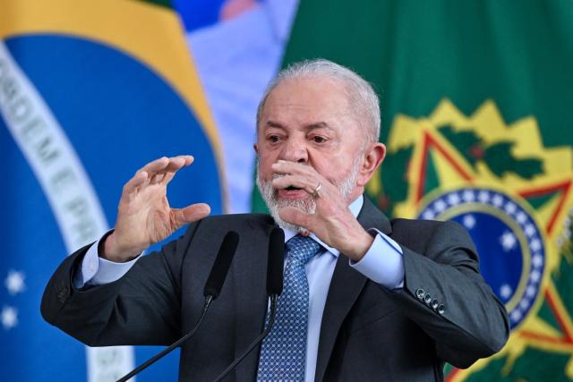 Brazil's President Luiz Inacio Lula da Silva gestures as he speaks during the signing ceremony of the new Income Tax Law at the Planalto Palace in Brasilia. on November 26, 2025. (Photo by Evaristo Sa / AFP)
