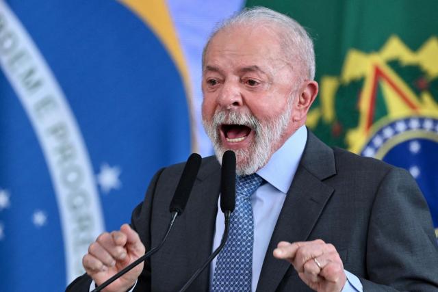 Brazil's President Luiz Inacio Lula da Silva gestures as he speaks during the signing ceremony of the new Income Tax Law at the Planalto Palace in Brasilia. on November 26, 2025. (Photo by Evaristo Sa / AFP)
