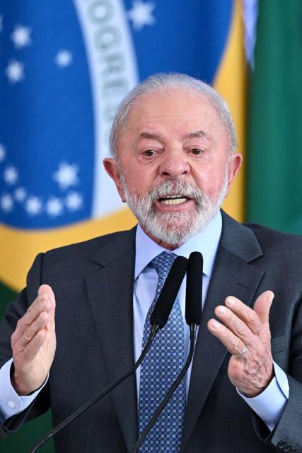 Brazil's President Luiz Inacio Lula da Silva gestures as he speaks during the signing ceremony of the new Income Tax Law at the Planalto Palace in Brasilia. on November 26, 2025. (Photo by Evaristo Sa / AFP)