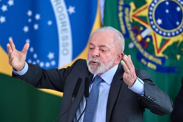 Brazil's President Luiz Inacio Lula da Silva gestures as he speaks during the signing ceremony of the new Income Tax Law at the Planalto Palace in Brasilia. on November 26, 2025. (Photo by Evaristo Sa / AFP)