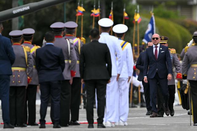Ecuador's Defence Minister Gian Carlo Loffredo (R) attends the change of command ceremony for the Joint Command of the Armed Forces at the Eloy Alfaro Superior Military School on the outskirts of Quito on November 26, 2025. (Photo by Rodrigo BUENDIA / AFP)