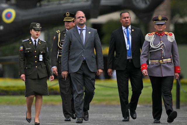 Ecuador's Interior Minister John Reimberg (C) attends the change of command ceremony for the Joint Command of the Armed Forces at the Eloy Alfaro Superior Military School on the outskirts of Quito on November 26, 2025. (Photo by Rodrigo BUENDIA / AFP)