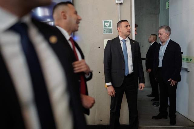 Former Colombian president and 2016 Nobel Peace Prize laureate Juan Manuel Santos (R) arrives for the commemoration of nine years of the peace agreement at Cinemateca in Bogota on November 26, 2025. (Photo by Sergio Yate / AFP)