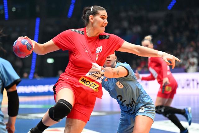 Serbia's #05 Emilija Lazic (L) and Uruguay's Uruguayan pivot #02 Julieta Pessina Portos vie for the ball during the preliminary round Group C match between Serbia and Uruguay during the IHF Women's Handball World Championship in Stuttgart, southwestern Germany on November 26, 2025. (Photo by THOMAS KIENZLE / AFP)