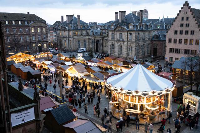 Visitors walk through the alleys of the Christmas market in Strasbourg, eastern France, on November 26, 2025. (Photo by ROMEO BOETZLE / AFP)