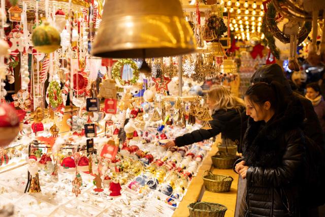 A woman looks at Christmas ornaments on a stall at the Christmas market in Strasbourg, eastern France, on November 26, 2025. (Photo by ROMEO BOETZLE / AFP)