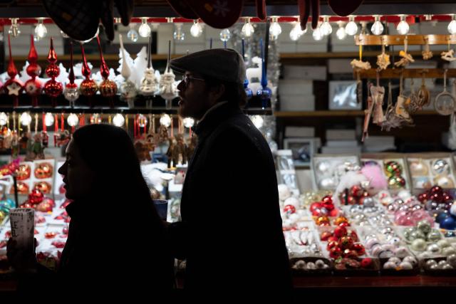 Visitors walk past a Christmas ornaments stall in an alley of the Christmas market in Strasbourg, eastern France, on November 26, 2025. (Photo by ROMEO BOETZLE / AFP)