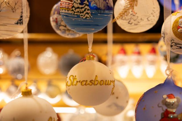 This photograph shows a Christmas ornament ball reading "Strasbourg" on a stall at the Christmas market in Strasbourg, eastern France, on November 26, 2025. (Photo by ROMEO BOETZLE / AFP)
