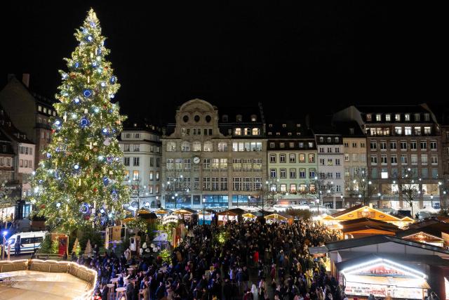 This photograph shows a giant Christmas tree on display at the Place Kleber during the Christmas market in Strasbourg, eastern France, on November 26, 2025. Strasbourg's Christmas market, a major tourist attraction in Alsace, opened its 300 chalets on November 26, 2025, in the center of a city under heightened security amid a persistent terrorist threat. (Photo by ROMEO BOETZLE / AFP)