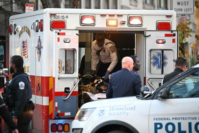An unidentified man in military fatigues lies on a stretcher inside an ambulance 26 November, 2025 in downtown Washington, DC. Two National Guard soldiers were shot a few blocks from the White House, according to law enforcement. (Photo by Drew ANGERER / AFP)