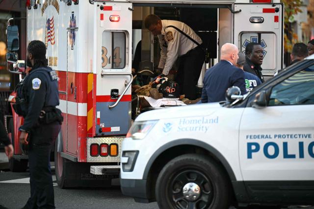 An unidentified man in military fatigues lies on a stretcher inside an ambulance 26 November, 2025 in downtown Washington, DC. Two National Guard soldiers were shot a few blocks from the White House, according to law enforcement. (Photo by Drew ANGERER / AFP)
