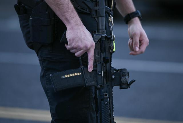 A law-enforcement officer holds their weapon as they secure the area after a shooting in downtown Washington, on November 26, 2025. On November 26, Police in Washington said they had detained a suspect after two National Guard troops were shot blocks away from the White House.
"The scene is secured. One suspect is in custody," The DC Police posted on X. (Photo by Brendan SMIALOWSKI / AFP)