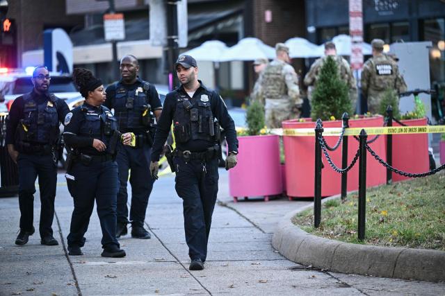 Law-enforcement officers secure the area after a shooting in downtown Washington, on November 26, 2025. On November 26, Police in Washington said they had detained a suspect after two National Guard troops were shot blocks away from the White House. "The scene is secured. One suspect is in custody," The DC Police posted on X. (Photo by Brendan SMIALOWSKI / AFP)