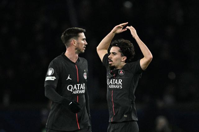 Paris Saint-Germain's Portuguese midfielder #17 Vitinha (R) celebrates after scoring his team's first goal during the UEFA Champions League, league phase - matchday 5, football match between Paris Saint-Germain (PSG) and Tottenham Hotspur FC at the Parc des Princes stadium in Paris on November 26, 2025. (Photo by JULIEN DE ROSA / AFP)