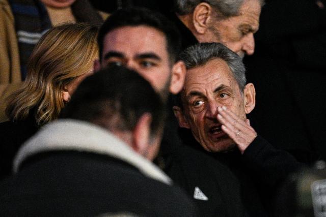 Former French President Nicolas Sarkozy (R) attends the UEFA Champions League, league phase - matchday 5, football match between Paris Saint-Germain (PSG) and Tottenham Hotspur FC at the Parc des Princes stadium in Paris on November 26, 2025. (Photo by JULIEN DE ROSA / AFP)
