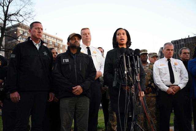 District of Columbia Mayor Muriel Bowser (2-R) accompanied by the FBI Director Kash Patel (2-L) speaks during a press conference after a shooting in downtown Washington, on November 26, 2025. On November 26, Police in Washington said they had detained a suspect after two National Guard troops were shot blocks away from the White House. Patel said the two Guard troops are in critical condition. (Photo by Drew ANGERER / AFP)