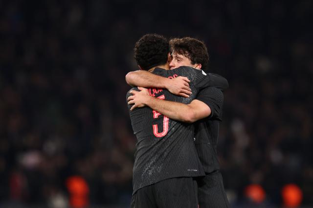 Paris Saint-Germain's Portuguese midfielder #87 Joao Neves (R) and Paris Saint-Germain's Brazilian defender #05 Marquinhos (L) embrace as they celebrate their victory at the end of the UEFA Champions League, league phase - matchday 5, football match between Paris Saint-Germain (PSG) and Tottenham Hotspur FC at the Parc des Princes stadium in Paris on November 26, 2025. (Photo by FRANCK FIFE / AFP)