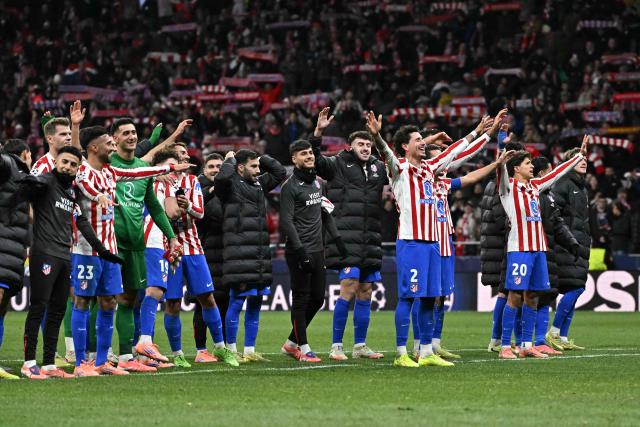 Atletico Madrid players celebrate after the UEFA Champions League, league phase day 5 football match between Club Atletico de Madrid and Inter Milan at the Metropolitano Stadium in Madrid on November 26, 2025. Atletico Madrid won 2-1. (Photo by Javier SORIANO / AFP)