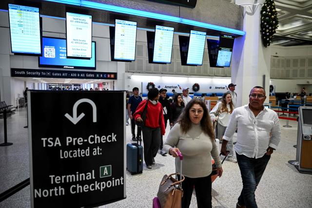 Travelers arrive at George Bush Intercontinental Airport in Houston, Texas, on November 26, 2025, on the eve of the Thanksgiving holiday. (Photo by RONALDO SCHEMIDT / AFP)