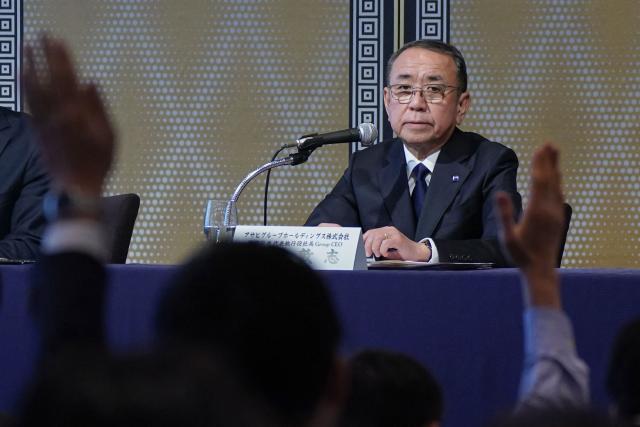 Asahi Group Holdings President and CEO Atsushi Katsuki speaks during a press conference at a hotel in Tokyo on November 27, 2025. Japanese beer giant Asahi said on November 27 it has delayed the release of full-year financial results due to a major ongoing cyberattack that began in late September. (Photo by Kazuhiro NOGI / AFP)
