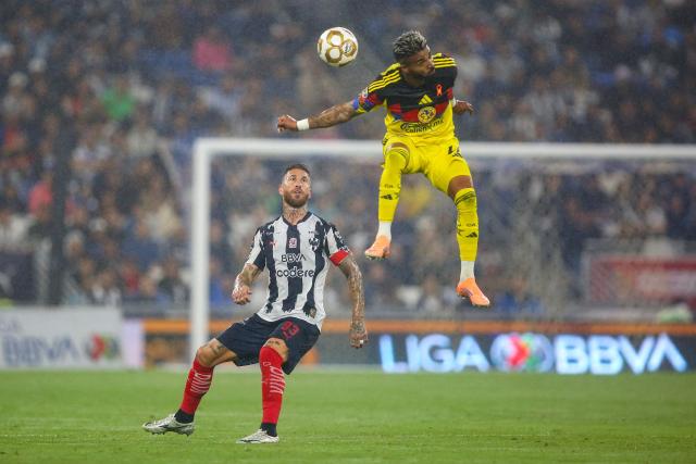 America's Uruguayan forward #27 Rodrigo Aguirre (R) heads the ball past Monterrey's Spanish defender #93 Sergio Ramos (L) during the Liga MX Apertura quarter-final first leg football match between Monterrey and America at the BBVA Stadium in Monterrey, Nuevo Leon state, Mexico, on November 26, 2025. (Photo by Julio Cesar AGUILAR / AFP)