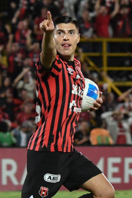 Alajuelense's Mexican forward #18 Ronaldo Cisneros celebrates scoring his team's first goal during the CONCACAF Central American Cup final first leg football match between Guatemala's Xelaju and Costa Rica's Alajuelense at the Alejandro Morera Soto Stadium in Alajuela, Costa Rica, on November 26, 2025. (Photo by Ezequiel BECERRA / AFP)