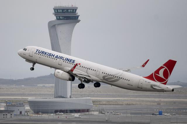 (FILES) A Turkish Airlines Airbus A321 plane takes off in front of the control tower at Istanbul Airport on the first day after moving from Ataturk International airport on April 6, 2019 in Istanbul. Venezuela announced that it had revoked the operating licenses of six airlines on November 26, 2025, accusing them of "terrorism" after they suspended their routes due to a warning issued by the United States about military activity in the region. The measure applies to Spain's Iberia, Portugal's TAP, Colombia's Avianca, Chile-Brazil's Latam, Brazil's GOL, and Turkey's Turkish Airlines. (Photo by OZAN KOSE / AFP)