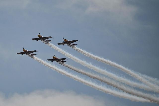 The Marksmen aerobatic team from South Africa performs during the Aero Asia 2025 in Zhuhai, in southern China's Guangdong province on November 27, 2025. Aero Asia 2025 is an international aviation and aerospace exhibition that runs between November 27 and 30. (Photo by Hector RETAMAL / AFP)