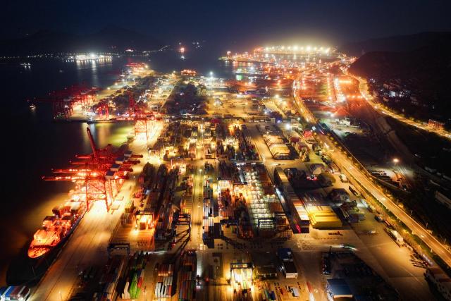 This aerial photo shows an aerial view of the container terminal at Lianyungang Port in Lianyungang, in China’s eastern Jiangsu province on November 26, 2025. (Photo by AFP) / China OUT