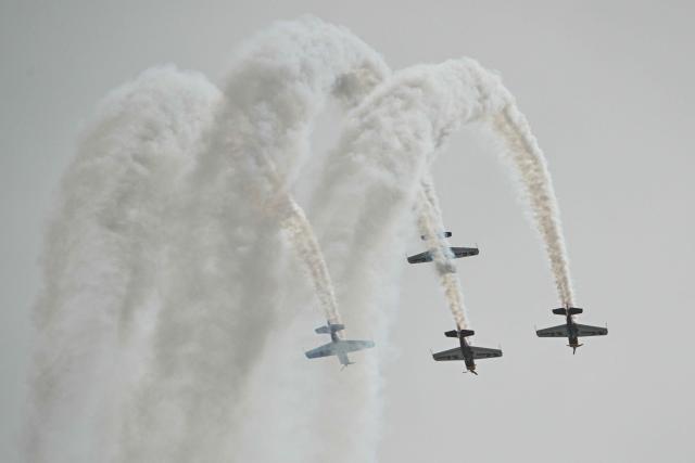 The Marksmen aerobatic team from South Africa performs during the Aero Asia 2025 in Zhuhai, in southern China's Guangdong province on November 27, 2025. Aero Asia 2025 is an international aviation and aerospace exhibition that runs between November 27 and 30. (Photo by Hector RETAMAL / AFP)