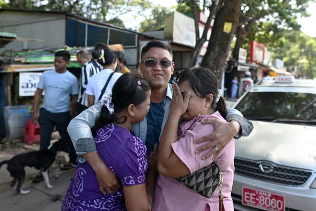 Relatives celebrate with a released inmate (C) outside Insein prison in Yangon on November 27, 2025. Prisoners were released from Insein prison in Yangon on November 27 a day after Myanmar's junta dropped the sentences of more than 3,000 people convicted under legislation that monitors say was wielded to crush post-coup dissent, encouraging them to vote in upcoming polls. (Photo by Sai Aung MAIN / AFP)