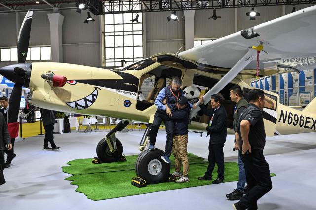 A cargo aircraft is seen in a booth during the Aero Asia 2025 in Zhuhai, in southern China's Guangdong province on November 27, 2025. Aero Asia 2025 is an international aviation and aerospace exhibition that runs between November 27 and 30. (Photo by Hector RETAMAL / AFP)