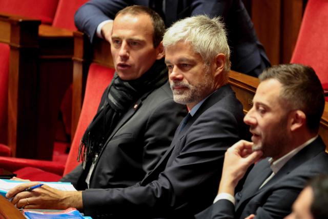 Droite Republicaine's MP Fabien Di Filippo (L), President of Droite Republicaine parliamentary group Laurent Wauquiez (C) look on during the opposition parliamentary time slot of French left-wing La France Insoumise (LFI) party at the French National Assembly, the French Parliament lower house, in Paris on November 27, 2025. (Photo by Ludovic MARIN / AFP)