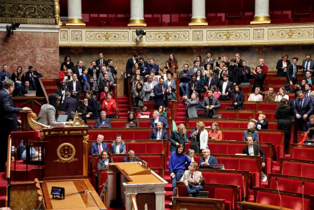 La France Insoumise - Nouveau Front Populaire's applaud after the adoption of their draft legislation during the opposition parliamentary time slot of French left-wing La France Insoumise (LFI) party at the French National Assembly, the French Parliament lower house, in Paris on November 27, 2025. (Photo by Ludovic MARIN / AFP)