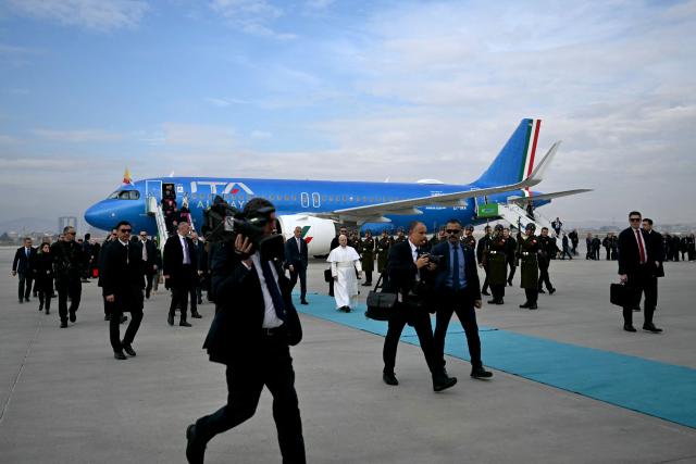 Pope Leo XIV disembarks from his plane after his arrival at Esenboga International Airport  in Ankara on November 27, 2025. Pope Leo XIV arrived in Turkey on the first overseas trip of his papacy, which will also take him to Lebanon. (Photo by OZAN KOSE / AFP)
