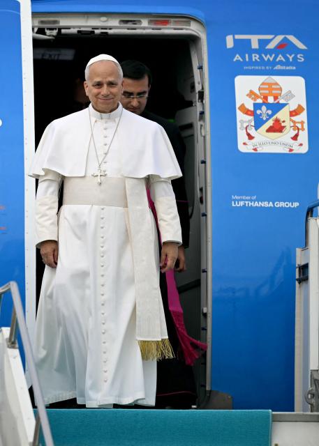 Pope Leo XIV disembarks from his plane after his arrival at Esenboga International Airport  in Ankara on November 27, 2025. Pope Leo XIV arrived in Turkey on the first overseas trip of his papacy, which will also take him to Lebanon. (Photo by Ozan KOSE / AFP)