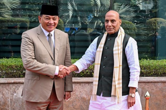 Indian Defence Minister Rajnath Singh (R) shakes hands with his Indonesian counterpart, Sjafrie Sjamsoeddin, before the third India-Indonesia Defence Ministers’ Dialogue in New Delhi on November 27, 2025. (Photo by Sajjad HUSSAIN / AFP)