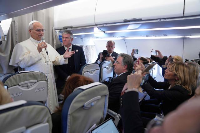 Pope Leo XIV greets reporters aboard a flight on his way to Ankara on November 27, 2025. Pope Leo XIV arrived in Turkey on the first overseas trip of his papacy, which will also take him to Lebanon. (Photo by Domenico Stinellis / POOL / AFP)