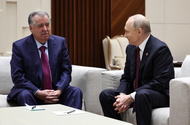 In this pool photograph distributed by the Russian state agency Sputnik, Russia's President Vladimir Putin meets with Tajikistan's President Emomali Rakhmon after a meeting of the Collective Security Treaty Organisation (CSTO) Heads of State Council in Bishkek on November 27, 2025. (Photo by Alexander KAZAKOV / POOL / AFP)