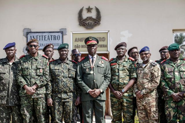 TOPSHOT - Guinea Bissau Army general Horta N'Tam (C) poses with other military leaders after being  sworn in as the transition leader and the leader of the High Command in Bissau on November 27, 2025. The Guinea-Bissau military appointed a general as the country's new leader Thursday for one year, a day after seizing power and arresting the president of the coup-prone west African nation.
"I have just been sworn in to lead the High Command," General Horta N'Tam declared after taking the oath of office in a ceremony at the military's headquarters, AFP journalists observed. Dozens of heavily armed soldiers were deployed at the scene. (Photo by Patrick MEINHARDT / AFP)