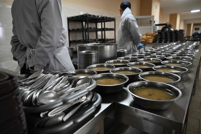 Russian prisoners of war have their lunch at a detention center for Russian POWs in western Ukraine on November 26, 2025, amid the Russian invasion of Ukraine. Since Russia invaded Ukraine in 2022, many reports have emerged of African nationals fighting alongside Moscow’s forces, with some accusing Russian military of using deceptive tactics to recruit them. In November, Kyiv said it had identified 1,426 fighters from 36 African countries serving in the Russian army. (Photo by Genya SAVILOV / AFP)