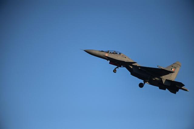 An Indian pilot takes off a Russian-made Sukhoi Su-30 fighter jet at a military air base during the Garuda 2025 French-Indian military cooperation exercise in Mont-de-Marsan, southwestern France, on November 26, 2025. (Photo by Christophe ARCHAMBAULT / AFP)
