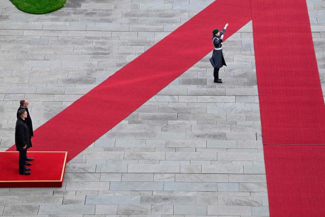 Germany's Chancellor Friedrich Merz (2nd L) and Estonia's Prime Minister Kristen Michal (L) review a military honor guard during an official welcome ceremony in front of the Chancellery in Berlin, Germany, on November 27, 2025. (Photo by John MACDOUGALL / POOL / AFP)
