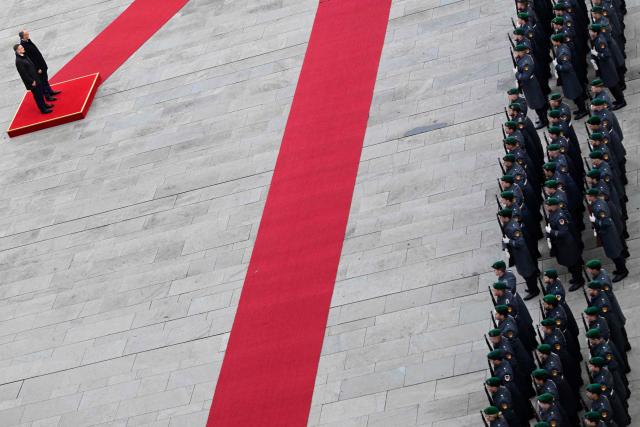Germany's Chancellor Friedrich Merz (2nd L) and Estonia's Prime Minister Kristen Michal (L) review a military honor guard during an official welcome ceremony in front of the Chancellery in Berlin, Germany, on November 27, 2025. (Photo by John MACDOUGALL / POOL / AFP)